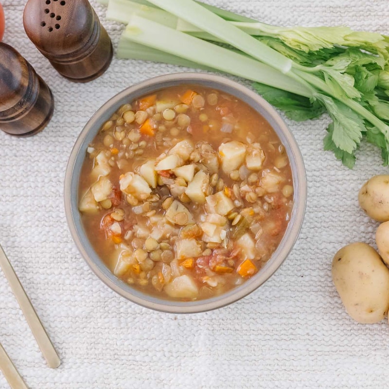 Bowl of healing postpartum food on a wooden table