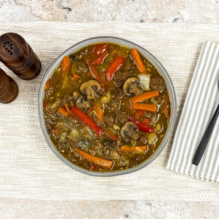 Mongolian Beef with mushrooms, carrots, and peppers in a large bowl