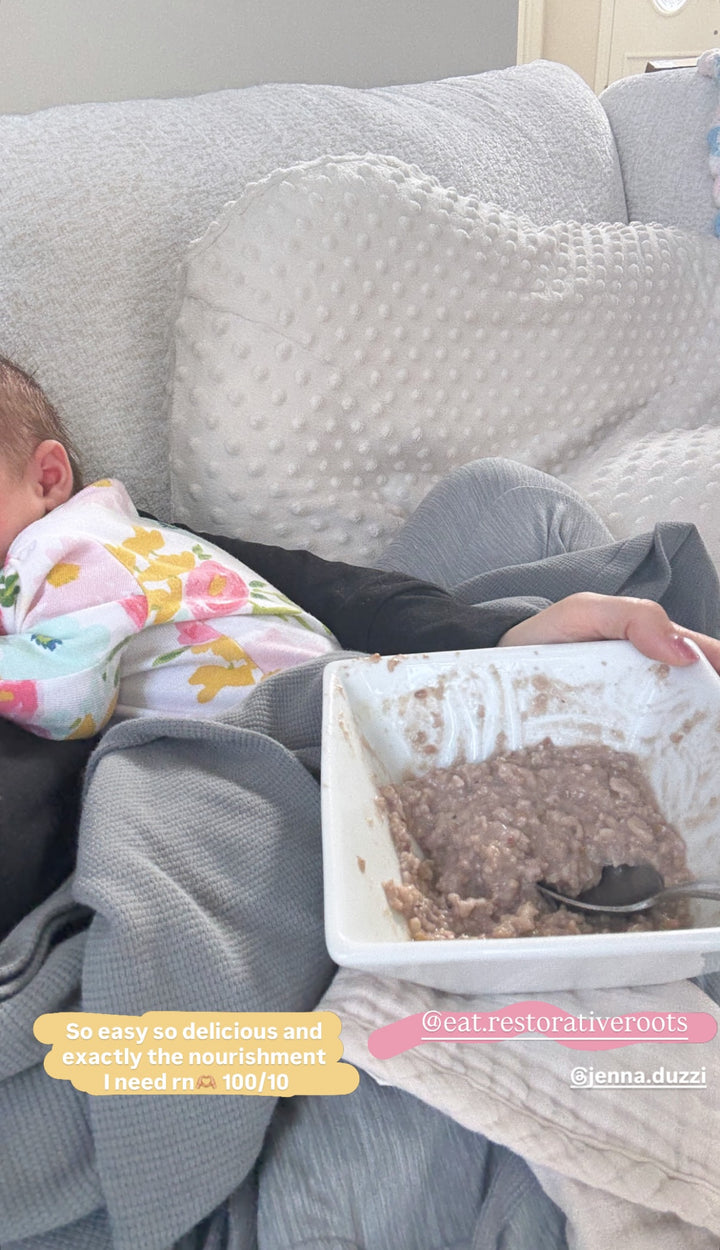 Mom eating very berry oatmeal with baby on lap