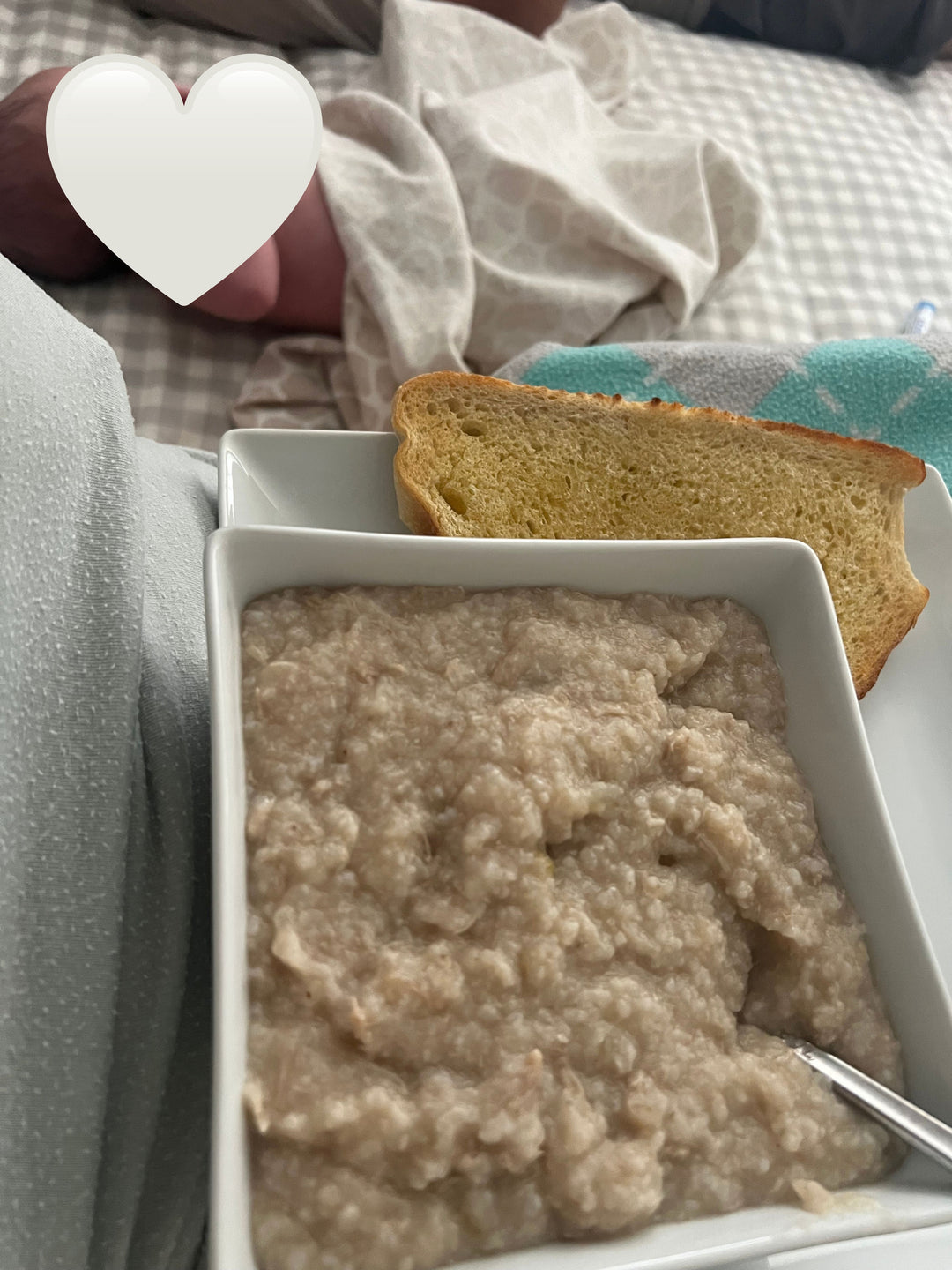 Mom eating creamy chicken and rice congee with baby nearby